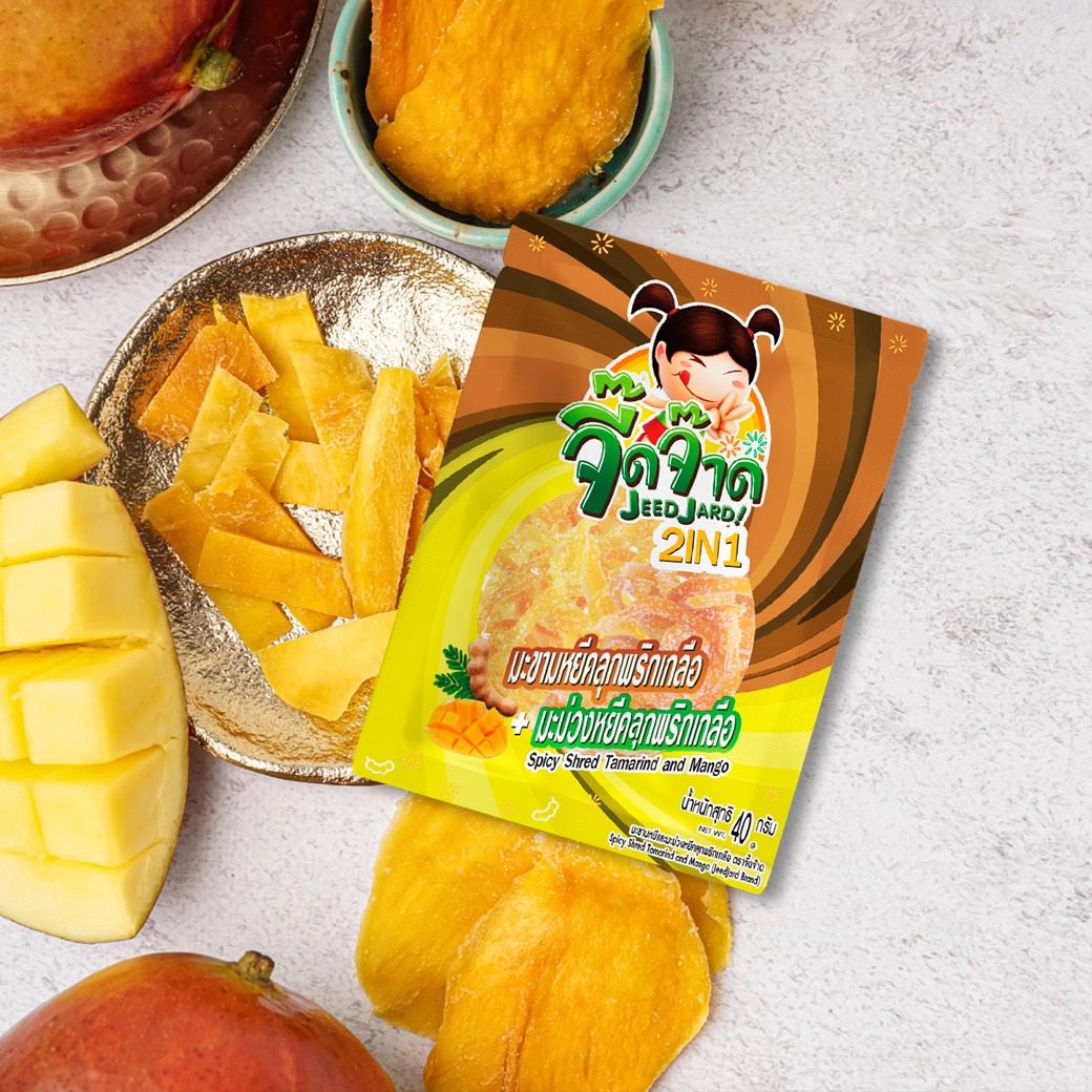 Capture a close-up studio shot of perfectly arranged dried mango slices on a glossy white surface. Focus on the texture, color, and shape of the mango slices, highlighting their natural beauty. Use soft, diffused lighting to avoid harsh shadows. The color palette should be warm and inviting. Style reference: Commercial food photography with a focus on aesthetics.
