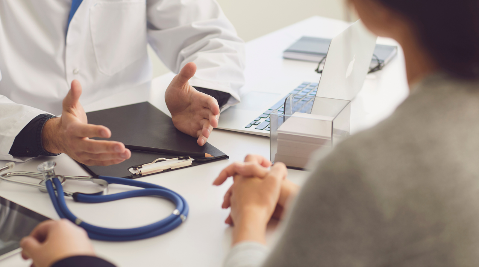 A female doctor consulting with a patient in her office. The doctor is smiling and attentive. The office is clean and professional.
