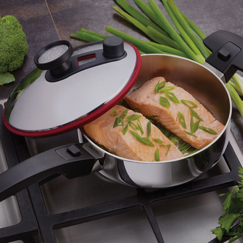 A close-up shot of a Royal Prestige stainless steel pot with a gleaming finish, showcasing its sturdy construction and thick base. The pot is filled with simmering soup, emitting steam and creating a warm, inviting atmosphere.  The background is blurred, focusing attention on the pot's quality.