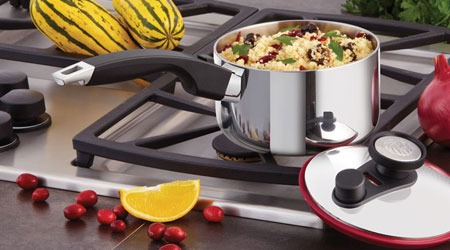 A photo of a Royal Prestige frying pan on a stovetop, with a sizzling steak placed in the center. The pan is filled with oil, and the heat is evenly distributed across the surface, as evidenced by the consistent sizzle of the steak and the absence of any hot spots.  The background is a modern kitchen with warm lighting.