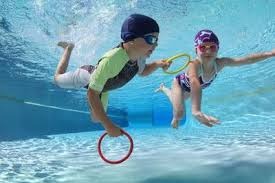 A photorealistic shot of a coach and student reviewing swim goals. They're sitting poolside, looking at a tablet displaying progress metrics and a personalized swim plan. The atmosphere is encouraging and collaborative. Capture the focus on data-driven progress and tailored objectives.
