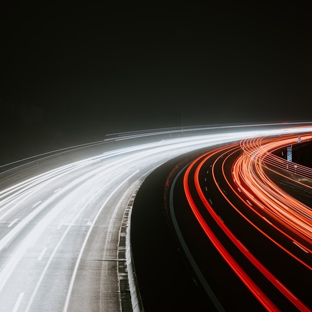 A photorealistic image of a smartphone screen loading a PWA almost instantaneously. A loading bar is visible, but it is nearly complete, showcasing the speed. The background is a blurred cityscape, symbolizing the app's global accessibility. Focus on clean lines and vibrant colors, creating a sense of speed and efficiency.