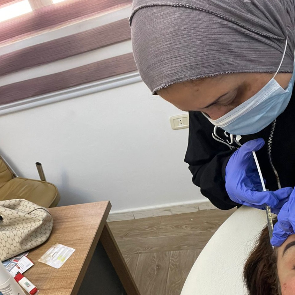 A portrait of Dr. Asma Almagrahi, radiating confidence and expertise, in a modern clinic setting. The image should convey professionalism and trustworthiness.