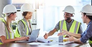 Create a photorealistic image showing a diverse team of professionals collaborating at a construction site, reviewing plans and coordinating efforts. The scene should emphasize teamwork, communication, and expertise. The lighting should be natural and bright, conveying a sense of progress and accomplishment. Colors should be earthy tones with accents of blue and green. Technical specs: 4K, photorealistic.