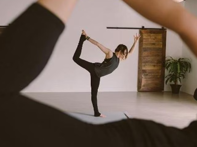 A close-up shot of a therapist discussing a treatment plan with a client, highlighting personalized attention and care. Include visual cues like treatment notes or tailored exercise plans.