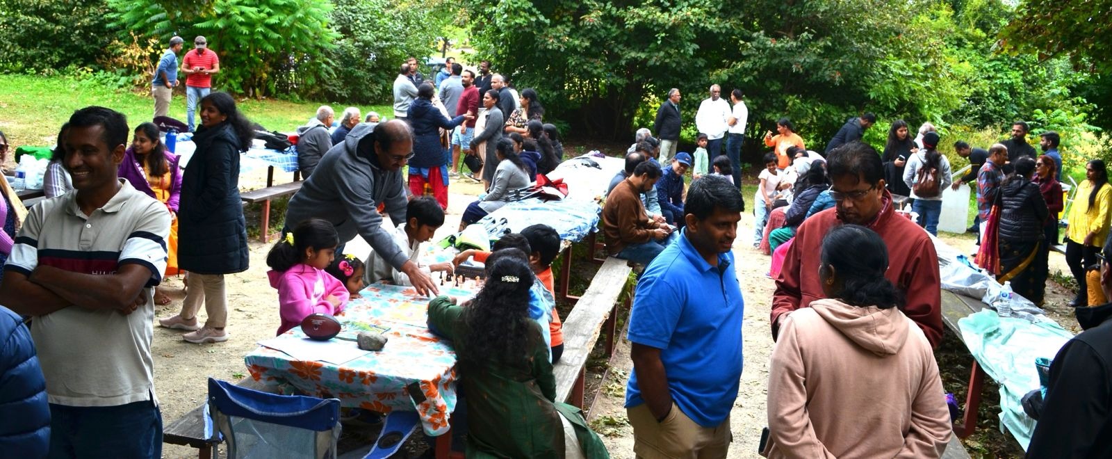 Create a photorealistic image of a Kammavar cultural celebration, featuring traditional dancers, music, and colorful attire. Focus on capturing the energy and excitement of the event. The lighting should be dramatic and dynamic. 4K resolution, high quality.