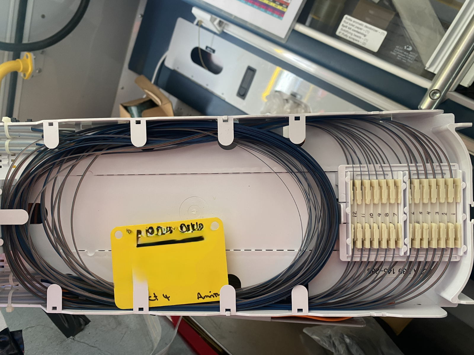 A photorealistic image demonstrating the placement of a splice protection sleeve over a fused fiber optic connection. The image should highlight the importance of protecting the splice from damage. Style: Practical, informative, and detailed.