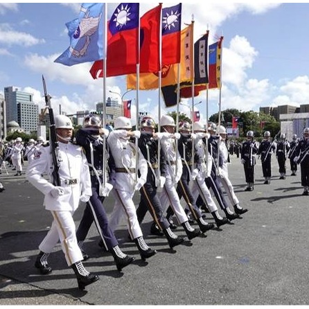 A wide shot of a parade with rows of soldiers in military uniforms marching in perfect formation.  They are holding rifles and flags, with tanks and armored vehicles in the background. The image should capture the sense of power and discipline of the military.